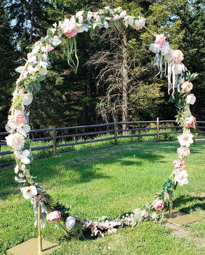 Circle moon arch for wedding ceremony with florals